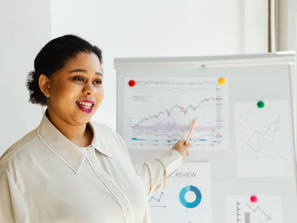 Person presenting an upward-trending growth chart